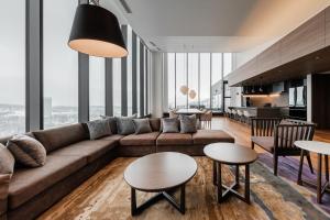 a living room with a couch and tables at The Vale Rusutsu in Rusutsu