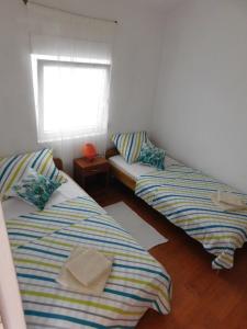 Postel nebo postele na pokoji v ubytování Apartmani Ruža