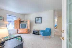 a living room with a blue chair and a television at 863 Juniper (MCA 499) in Manzanita