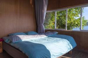 a bed in a room with a window at The Lake House Dalat in Da Lat