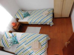 Postel nebo postele na pokoji v ubytování Apartmani Ruža