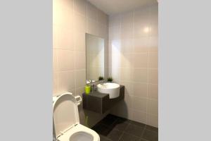 a bathroom with a toilet and a sink at ZY Studio @ EVO SOHO Bangi [ASTRO WiFi NETFLIX] in Bangi
