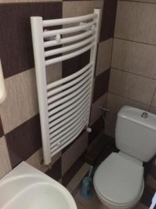a bathroom with a white toilet and a sink at Pensiunea Everest in Craiova