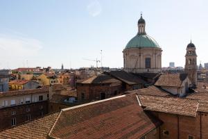 a view of a city with a cathedral and roofs at Missori Suites in Milan