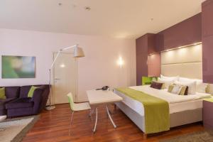 A bed or beds in a room at Mamaison All-Suites Spa Hotel Pokrovka