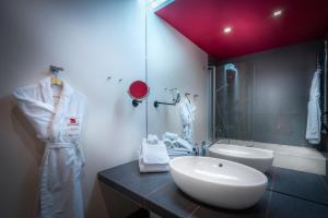a bathroom with a sink and a mirror at Mamaison All-Suites Spa Hotel Pokrovka in Moscow