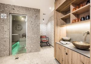 a bathroom with a sink and a glass shower at Andre Arnold - Boutique Pension in Sölden
