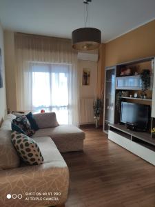 a living room with a couch and a flat screen tv at La casa della sposa in Trani