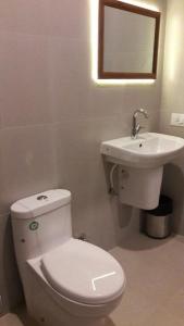 a bathroom with a white toilet and a sink at Peter’s vacation rentals Goa in Calangute +17 photos