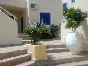 two plants in a large pot on the steps of a building at Frida Village in Hersonissos