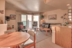 a kitchen and living room with a table and chairs at Dock of the Bay 305 in Lincoln City
