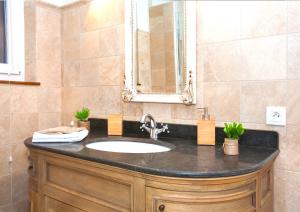 a bathroom with a sink and a mirror at Centre - L'Impérial - Parking in Saverne