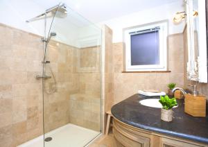 a bathroom with a shower and a sink at Centre - L'Impérial - Parking in Saverne