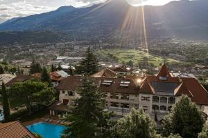 a view of a town with a mountain in the background at Romantik Hotel Oberwirt in Marlengo