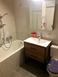een badkamer met een wastafel, een bad en een toilet bij Au village d'Evolène, bel appartement avec terrasse in Evolène