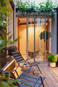 a patio with chairs and a table on a deck at Tinah Paris, Champs Elysées in Paris