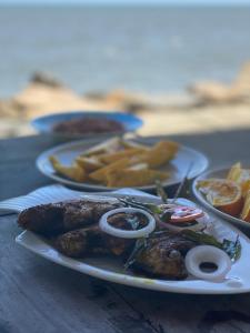 a plate of food on a wooden table at Cherai Onetree Retreat in Cherai Beach