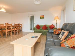 a living room with a couch and a table at The Outlook in Taunton