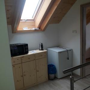 a small kitchen with a refrigerator and a window at apartman u\Kapra in Jeřmanice