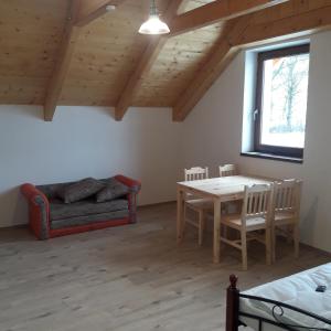 a living room with a table and a couch at apartman u\Kapra in Jeřmanice