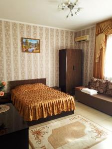 a bedroom with a bed and a couch at Десятка in Adler