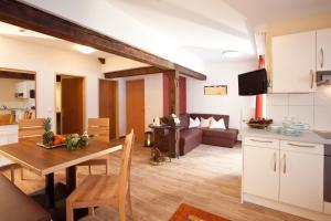 a kitchen and living room with a table and a couch at Appartements Fliana Mathon/Ischgl in Ischgl