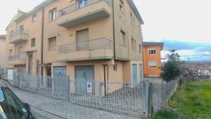 a building with a fence in front of it at Residenza Cleopatra 4 in Falconara Marittima