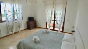 a bedroom with a bed with towels on it at Residenza Cleopatra 4 in Falconara Marittima