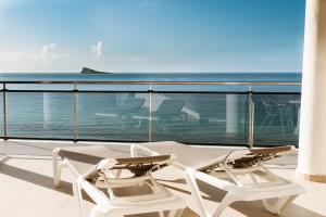 two chairs on a balcony with a view of the ocean at Hotel Marconi in Benidorm +28 photos