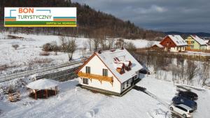 a house on the side of a snow covered mountain at Pensjonat Orle Gniazdo in Jelenia Góra