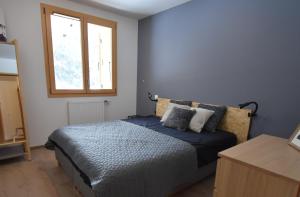 a bedroom with a bed and a window at VAUJANYLOCATIONS - Le Chalet d Antoine et Mary in Vaujany +7 photos