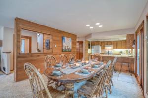 a kitchen and dining room with a wooden table and chairs at Red Cedar Lane 60 - Meredith Lodging in Sunriver