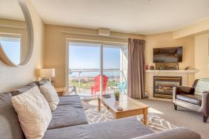 a living room with a couch and a table at Birds Nest Suite in Lincoln City