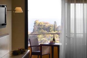 a kitchen with a table and a window with a view at Taormina Panoramic Hotel in Taormina