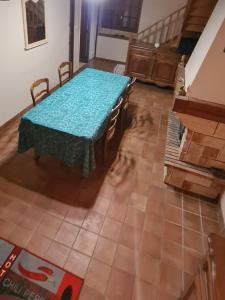 a table and chairs in a room with a floor at les jonquilles in Bussière-Galant