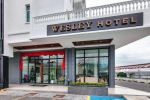 a westley hotel building with a sign on it at Wesley Hotel in Bukit Mertajam