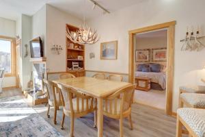 a dining room with a table and chairs and a bedroom at Sh504 Summit House Condo in Copper Mountain