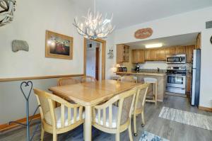 a kitchen and dining room with a wooden table and chairs at Sh504 Summit House Condo in Copper Mountain