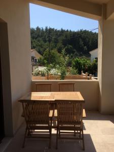 a wooden table and two chairs on a balcony at Aria Monte Villas in Raches +33 photos