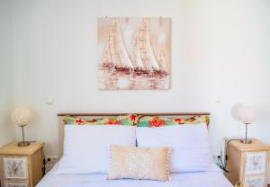 a bedroom with a bed with a painting above it at OLEA Apartments Vir in Vir