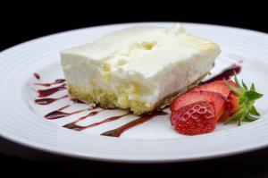 a piece of cake on a white plate with strawberries at Arha Reserva del Saja in Renedo