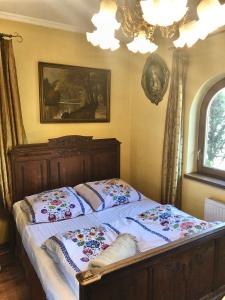 a bedroom with a bed with two pillows on it at Straszny Dwór in Zakopane