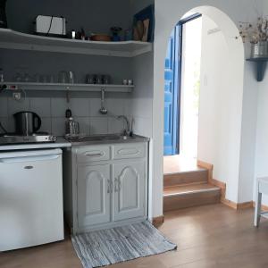 a kitchen with a sink and a dishwasher at Aloni in Kamilari