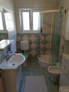 a bathroom with a shower and a sink and a toilet at Apartment Kika *** in Pučišća