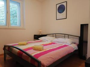 a bedroom with a large bed with pillows on it at Apartment Kika *** in Pučišća