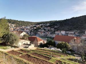 a view of a small town with houses and trees at Apartment Kika *** in Pučišća