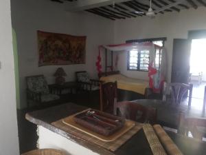 a dining room with a table and chairs and a room with a dining room at Chiky Villa in Watamu
