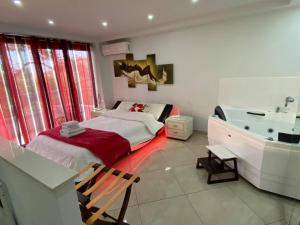 a bedroom with a bed and a sink in it at Mesogios House Suites in Larnaca