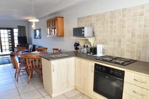 a kitchen with a stove and a counter top at 12 Settler Sands Beachfront cottage with sea view in Port Alfred