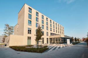 a large building on a street next to a road at Jugendherberge Oldenburg "DJH Mitgliedschaft erforderlich - membership required" in Oldenburg